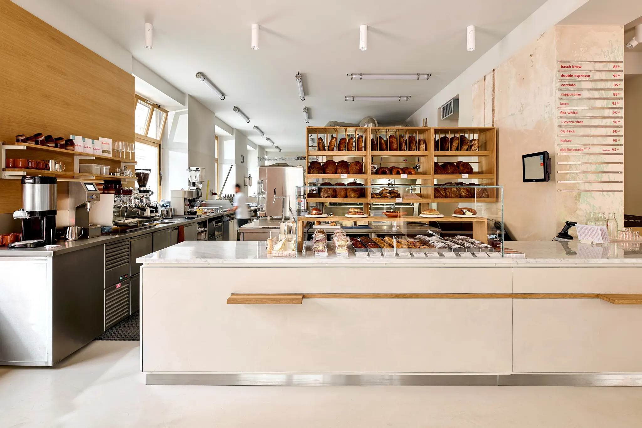 The interior of the Eska bakery in Letná with a counter and baked goods on display.